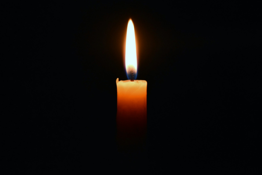 płonąca świeca na czarnym tle