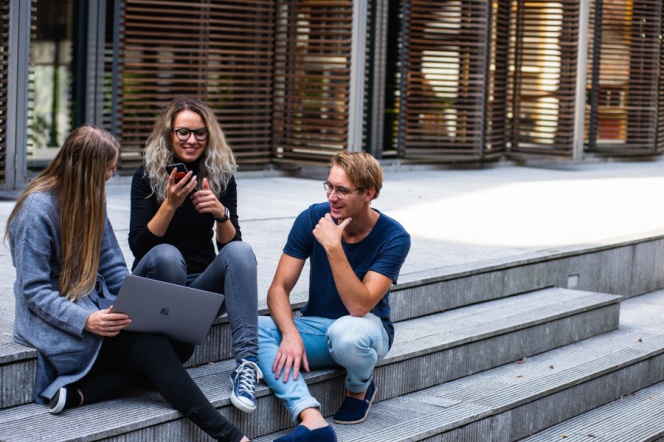 students sitting outside a building