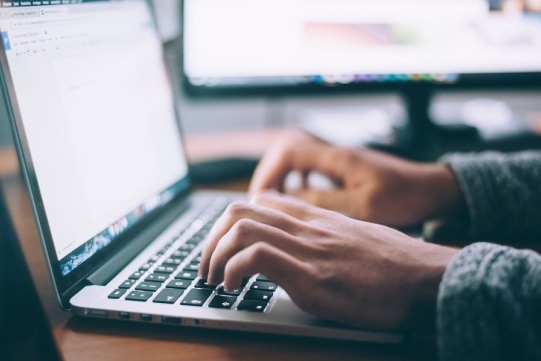 Hands on the laptop keyboard