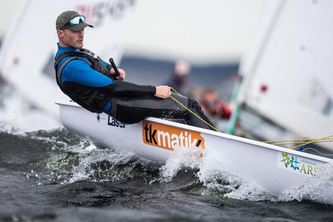 In the photo, there is Filip Ciszewski, vice-champion of senior Europe in the Olympic Laser Radial class. He is in a sailing boat at sea among waves.