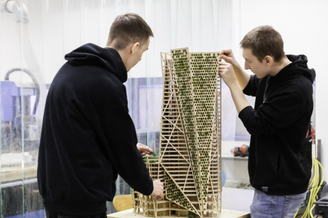 Two students building a wooden construction