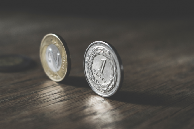 Zdjęcie przedstawia dwie monety "stojące" na rancie 1 zł oraz 2 zł