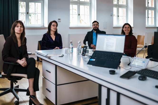 A photograph showing the Young Scientists Team seated at a table.