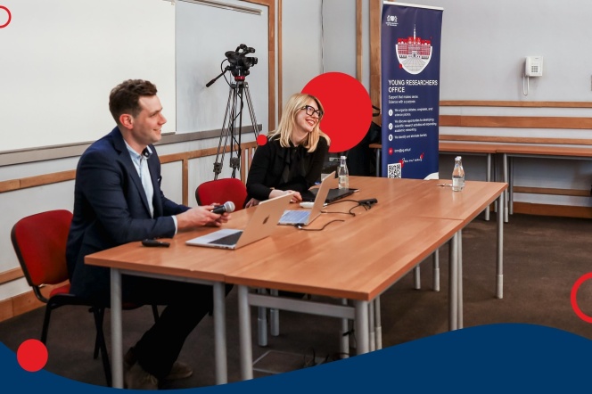 A photograph showing the presenters seated at a table.