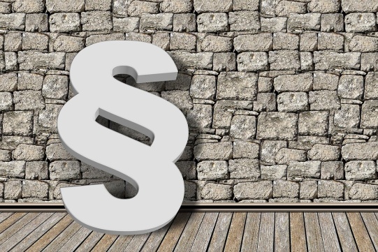 White paragraph sing, stone wall in the background