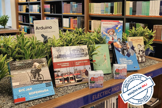 książki ustawione w sztucznej trawie na półce bibliotecznej