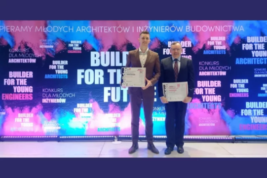 Na zdjęciu znajduje się dwóch mężczyzn na tle kolorowego baneru