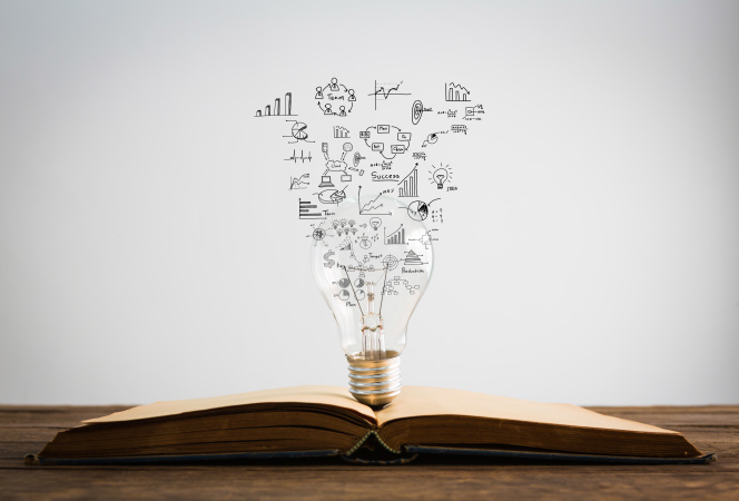 bulb standing on the book with icons symbolizing ideas