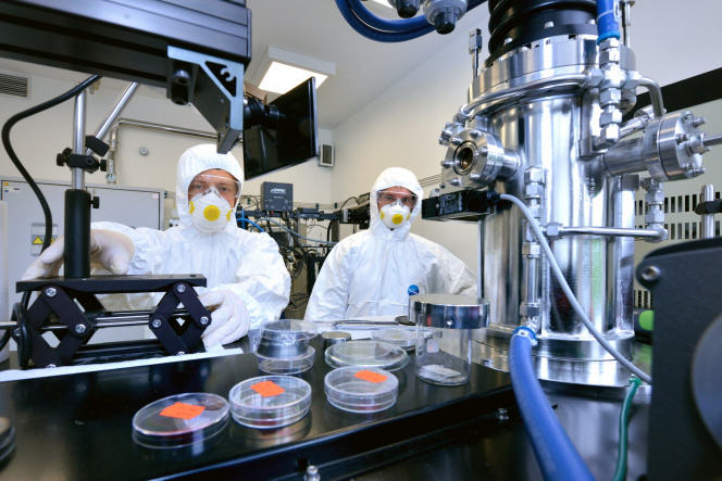 scientists in protective clothing in specialized laboratory 