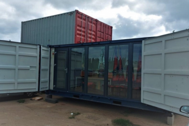 Navy-blue container, or Mobile Student Workship within the premises of Stocznia Cesarska